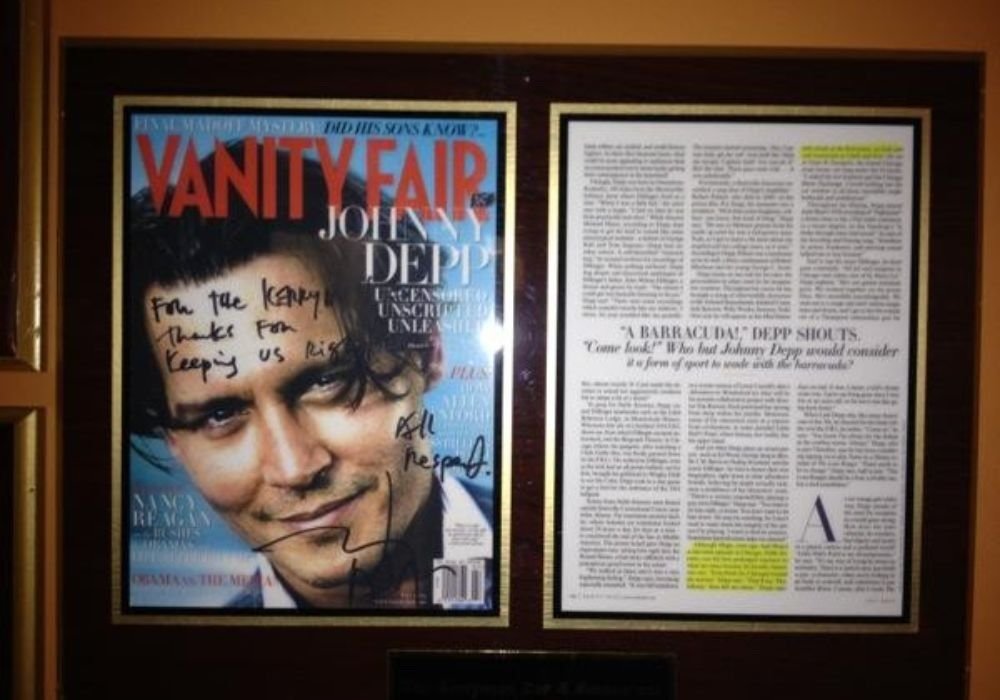 framed photo of a vanity fair magazine cover with Johnny Depp's autograph and an article about the public enemy movie